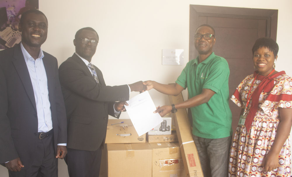 Dr. Ainooson receives items from GIZ